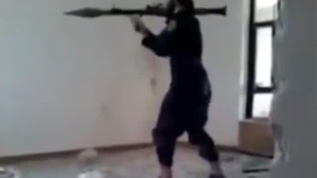 Daesh insurgent fires an RPG inside a room
